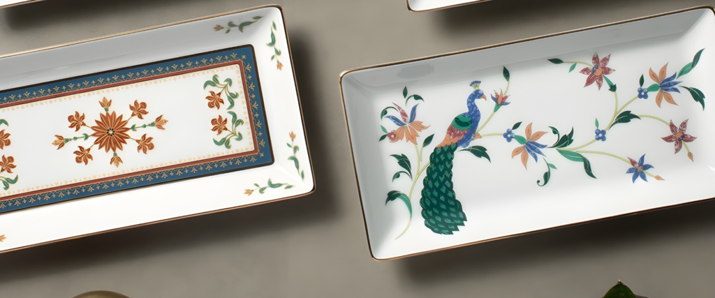 Elegant rectangular Noritake porcelain dishes featuring intricate floral and peacock designs.